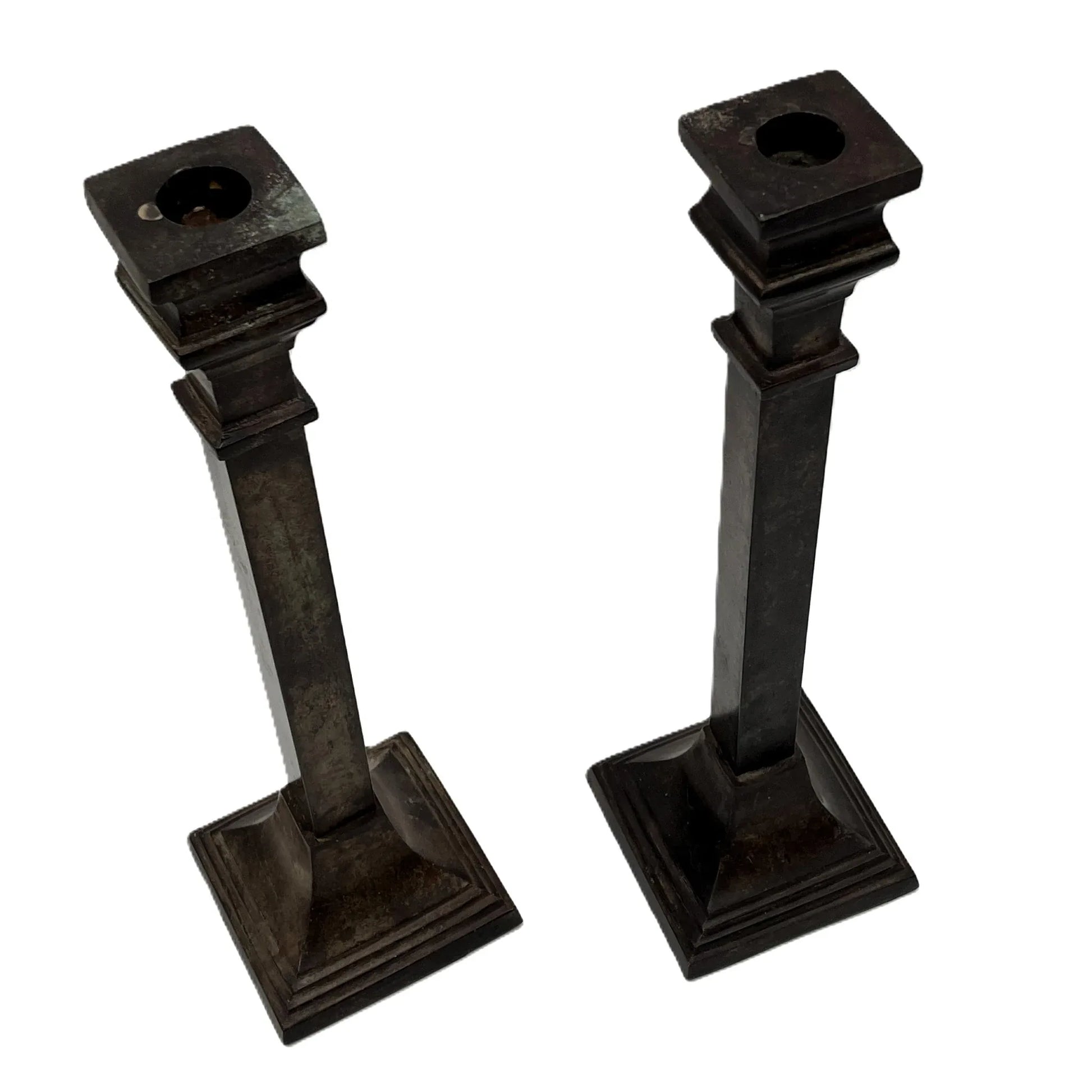 These are a heavy pair of cast metal candlesticks with a bronze or bronze coloured metal patina look. 
