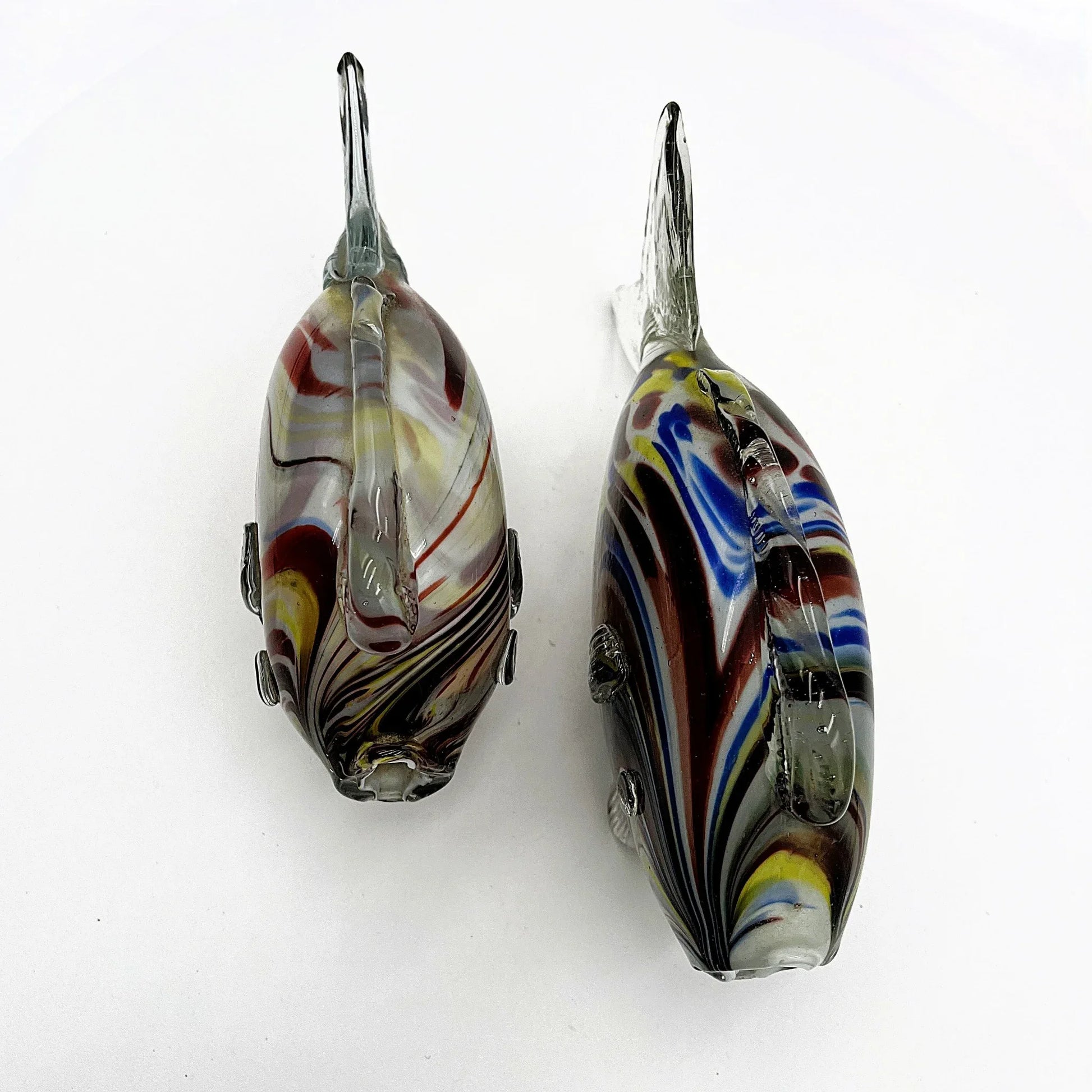This is a pair of mid-century Spatter, End of Day, or marbled fish.  They feature a colourful marbled design with clear glass fins.
