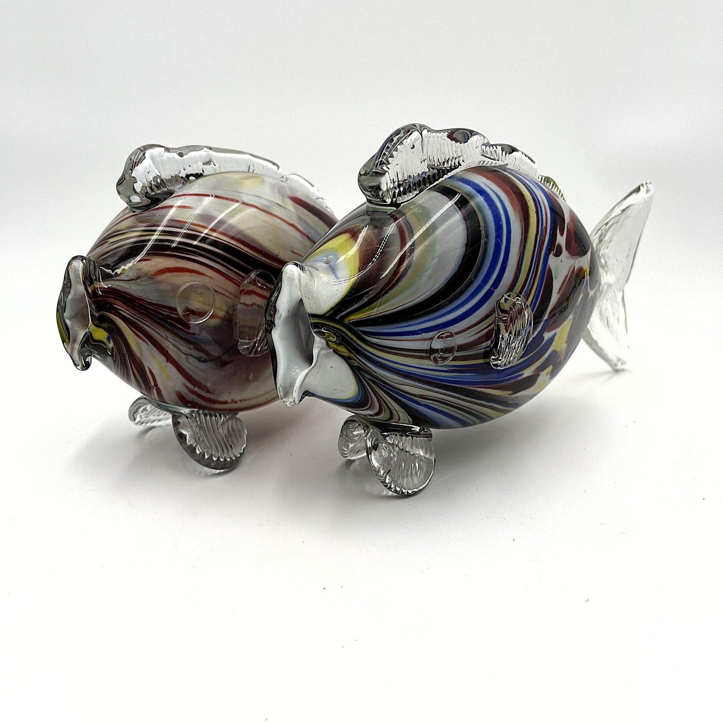 This is a pair of mid-century Spatter, End of Day, or marbled fish.  They feature a colourful marbled design with clear glass fins.