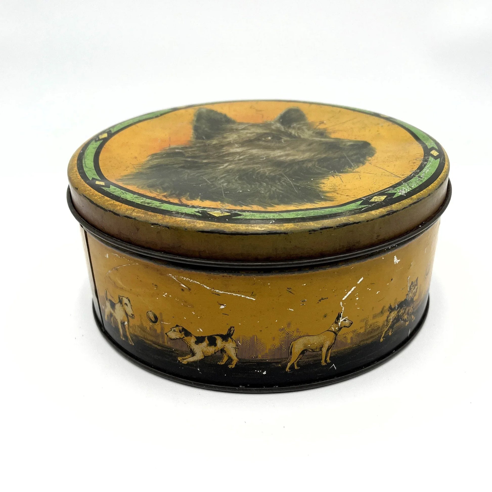 This is a smaller Pictorial Dog Mackintosh's Keillers Vintage Advertising toffee tin. It has a lovely picture of a Terrier on the lid and an assortment of dog breeds depicted around the sides of the tin.
