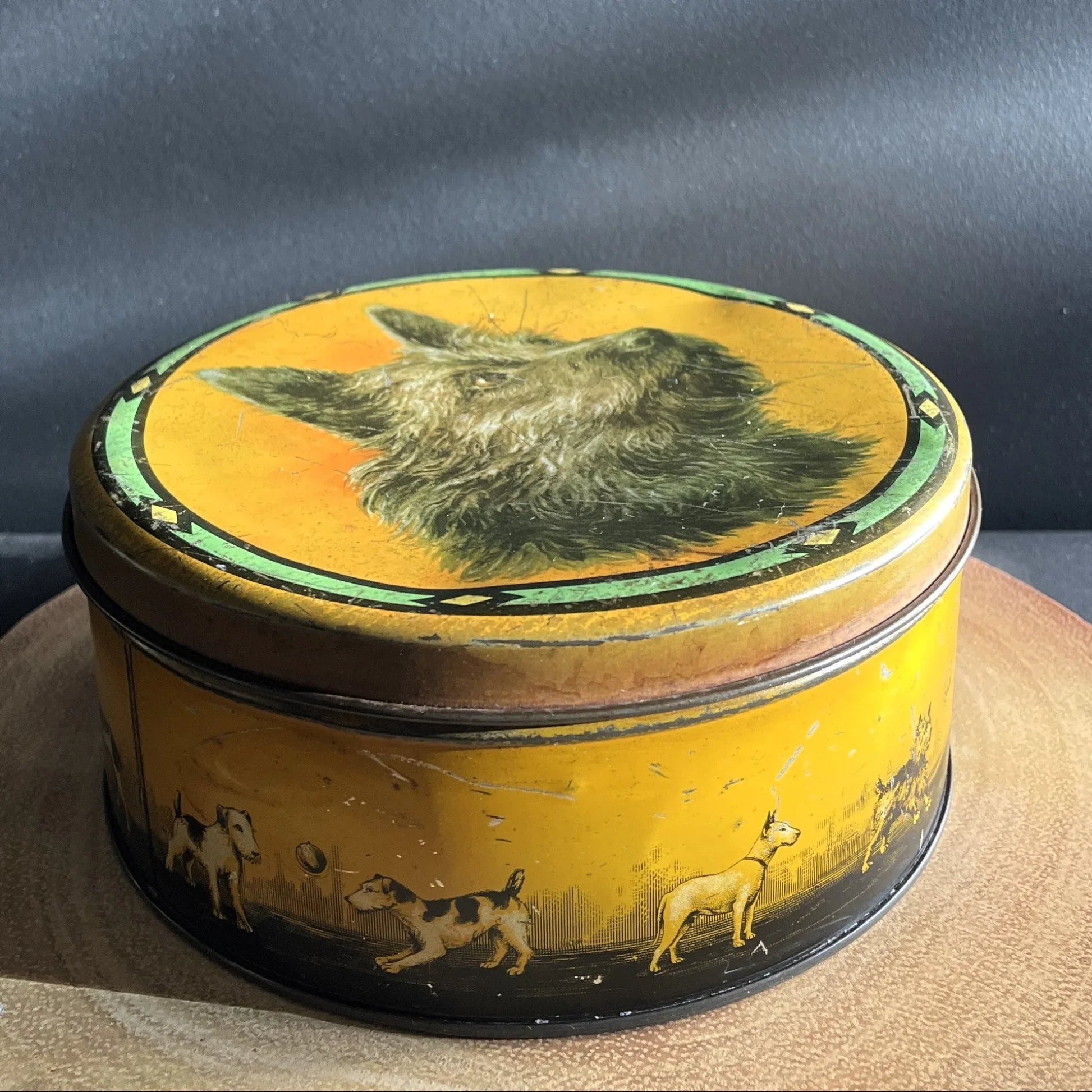 This is a smaller Pictorial Dog Mackintosh's Keillers Vintage Advertising toffee tin. It has a lovely picture of a Terrier on the lid and an assortment of dog breeds depicted around the sides of the tin.