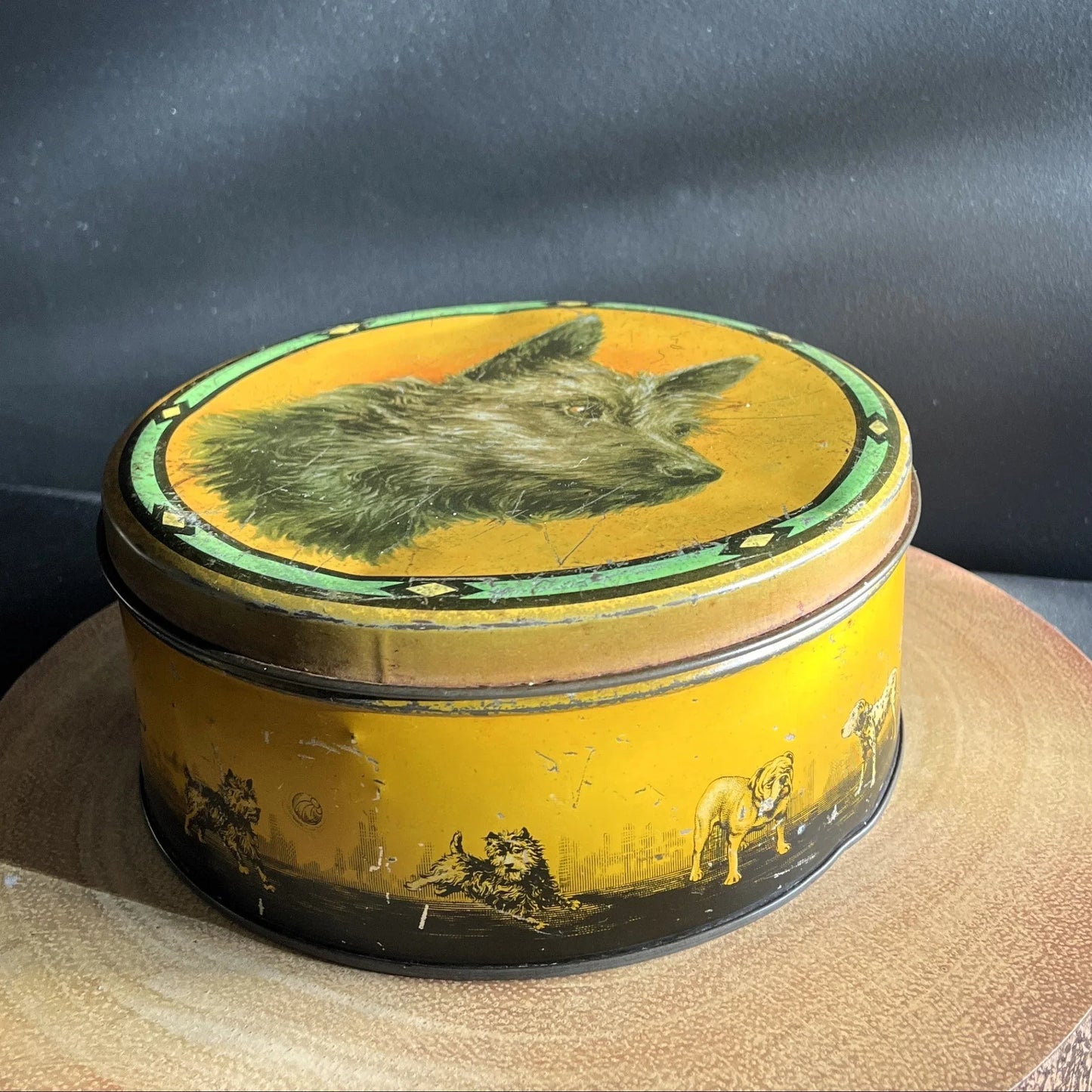 This is a smaller Pictorial Dog Mackintosh's Keillers Vintage Advertising toffee tin. It has a lovely picture of a Terrier on the lid and an assortment of dog breeds depicted around the sides of the tin.