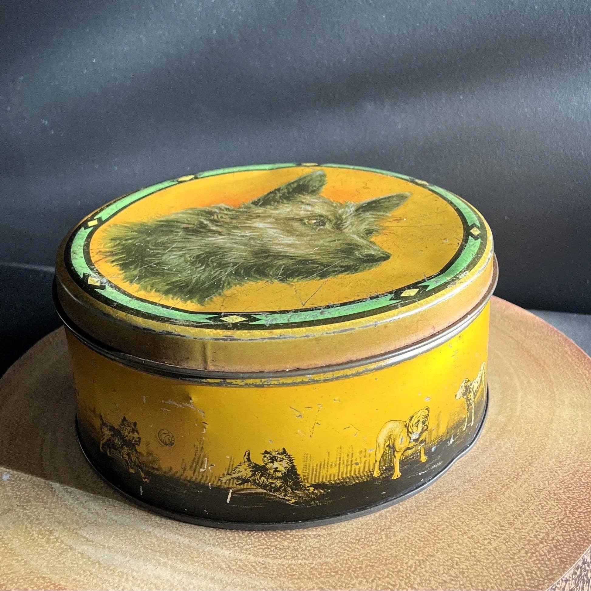 This is a smaller Pictorial Dog Mackintosh's Keillers Vintage Advertising toffee tin. It has a lovely picture of a Terrier on the lid and an assortment of dog breeds depicted around the sides of the tin.