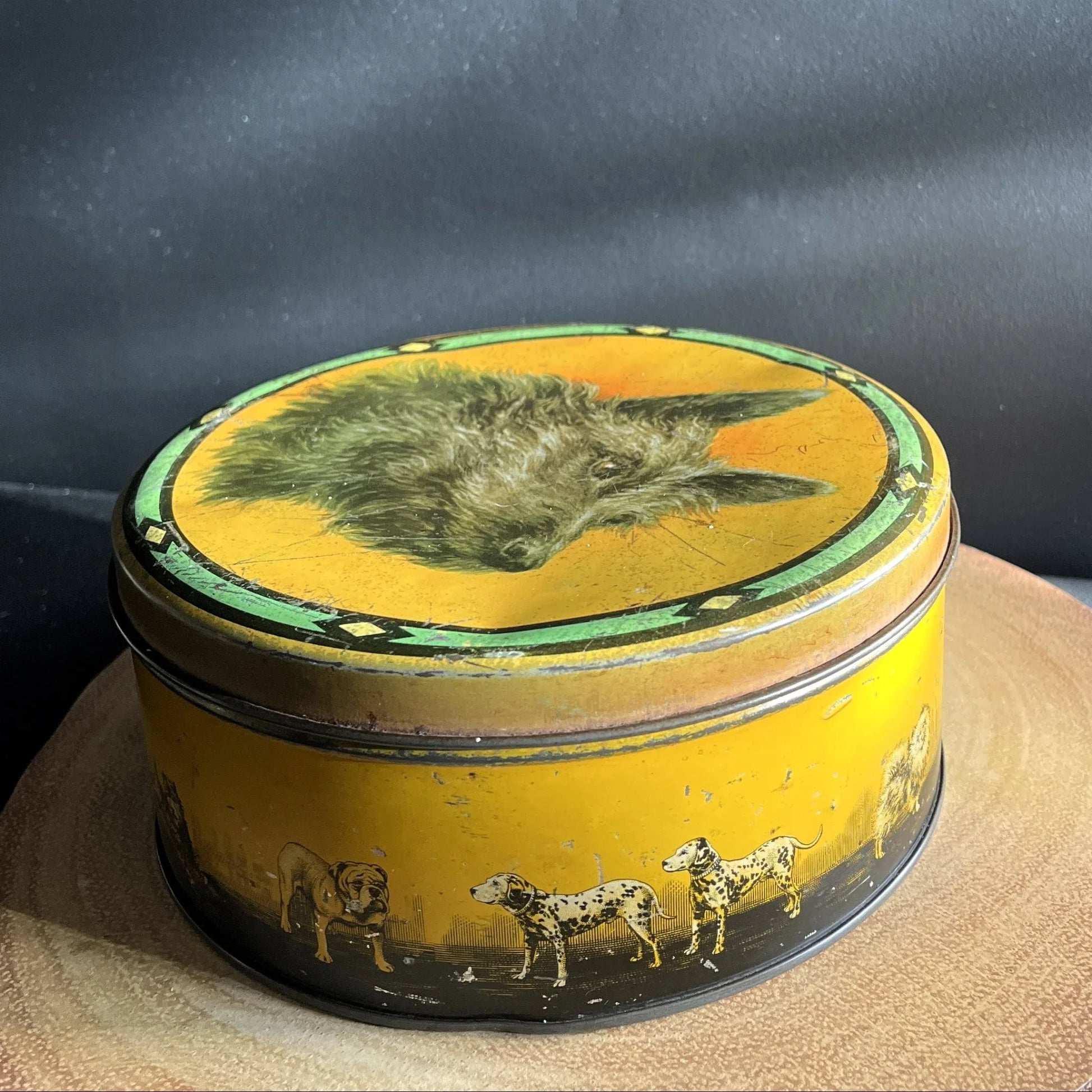 This is a smaller Pictorial Dog Mackintosh's Keillers Vintage Advertising toffee tin. It has a lovely picture of a Terrier on the lid and an assortment of dog breeds depicted around the sides of the tin.