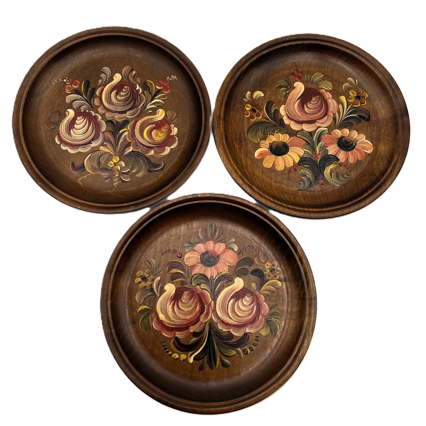 These are a set of 3 Vintage Wooden Hand Painted Decorative wall plates. Painted, I believe in a Norwegian Style with multicolour flower designs, 