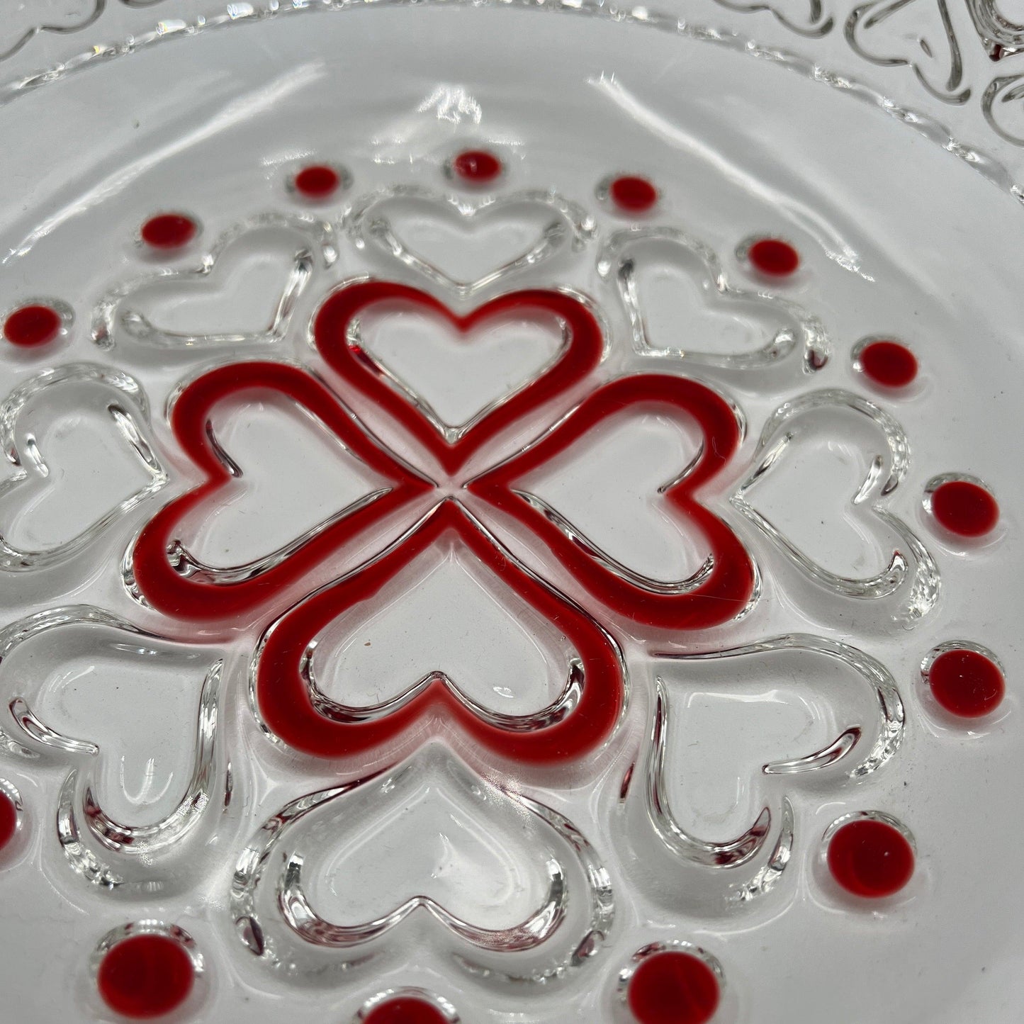 This is a vintage Walther Glas "Sweetheart" design serving bowl with a red heart and dot pattern. It is a round, clear glass bowl with a crimped edge and heart pattern design.