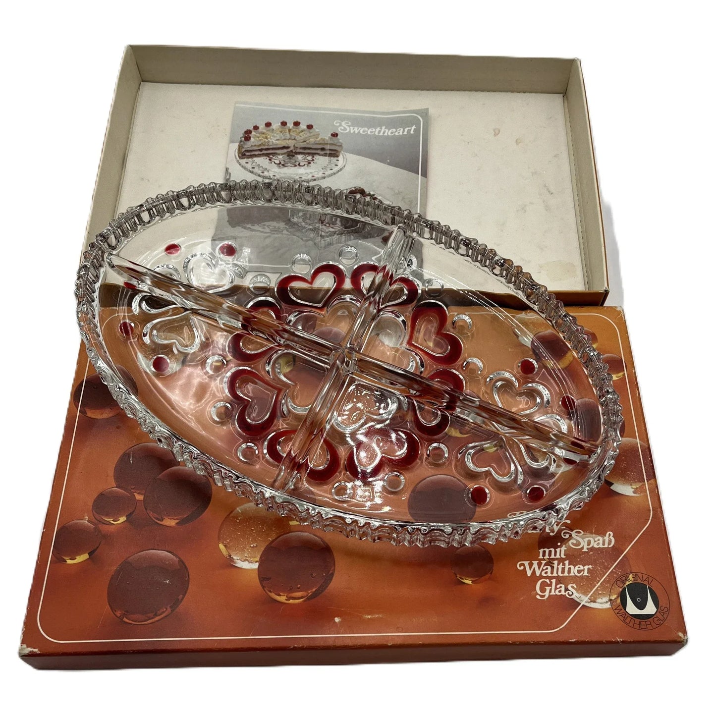 This is a vintage Walther Glas "Sweetheart" serving bowl, designed as a snack or sweets dish with a red heart and dot pattern. It is an oval, clear glass divided serving dish with a crimped edge.

