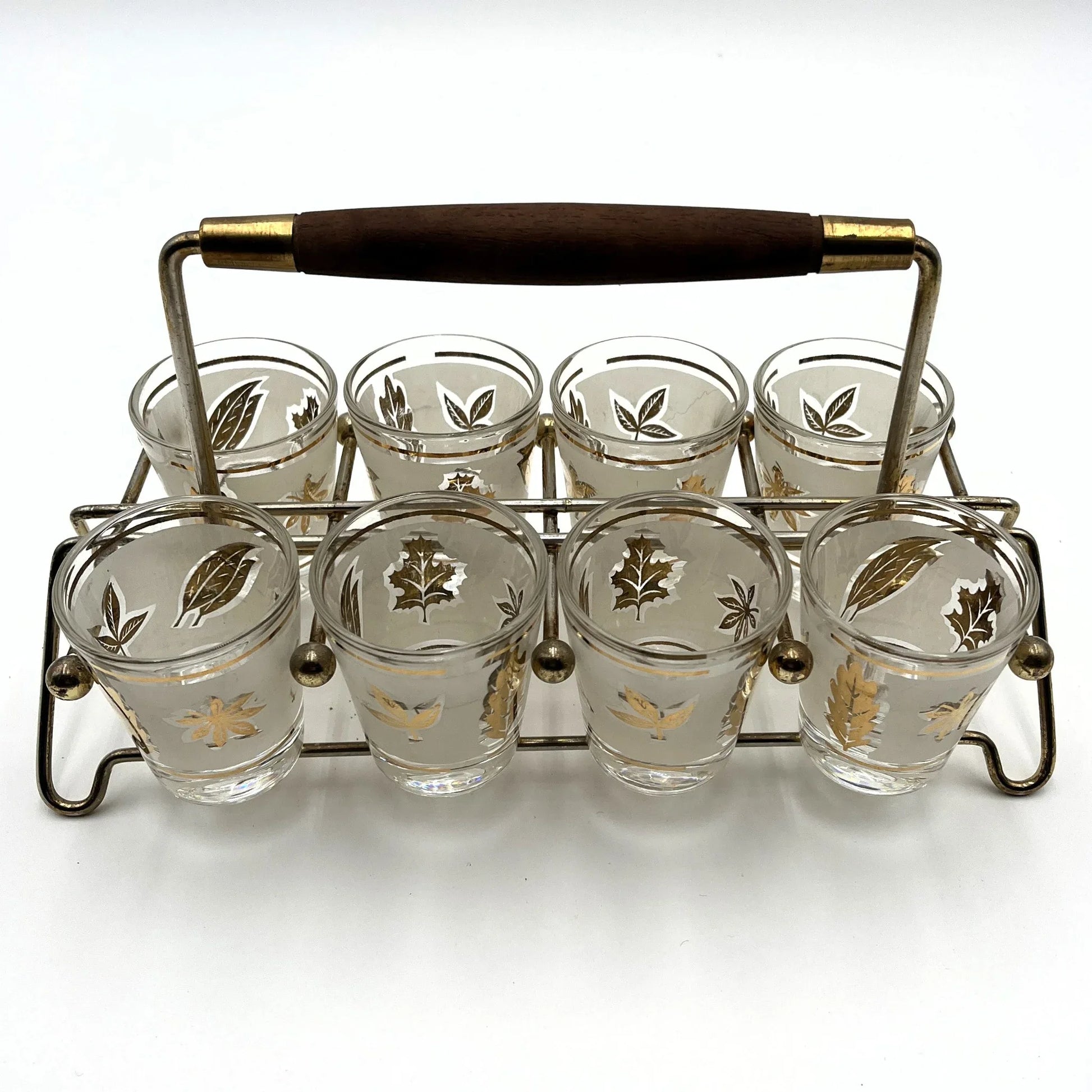 Manufactured in the 1960s, these are a set of 8 vintage Libby frosted gold foil leaf shot glasses, with their own stand.