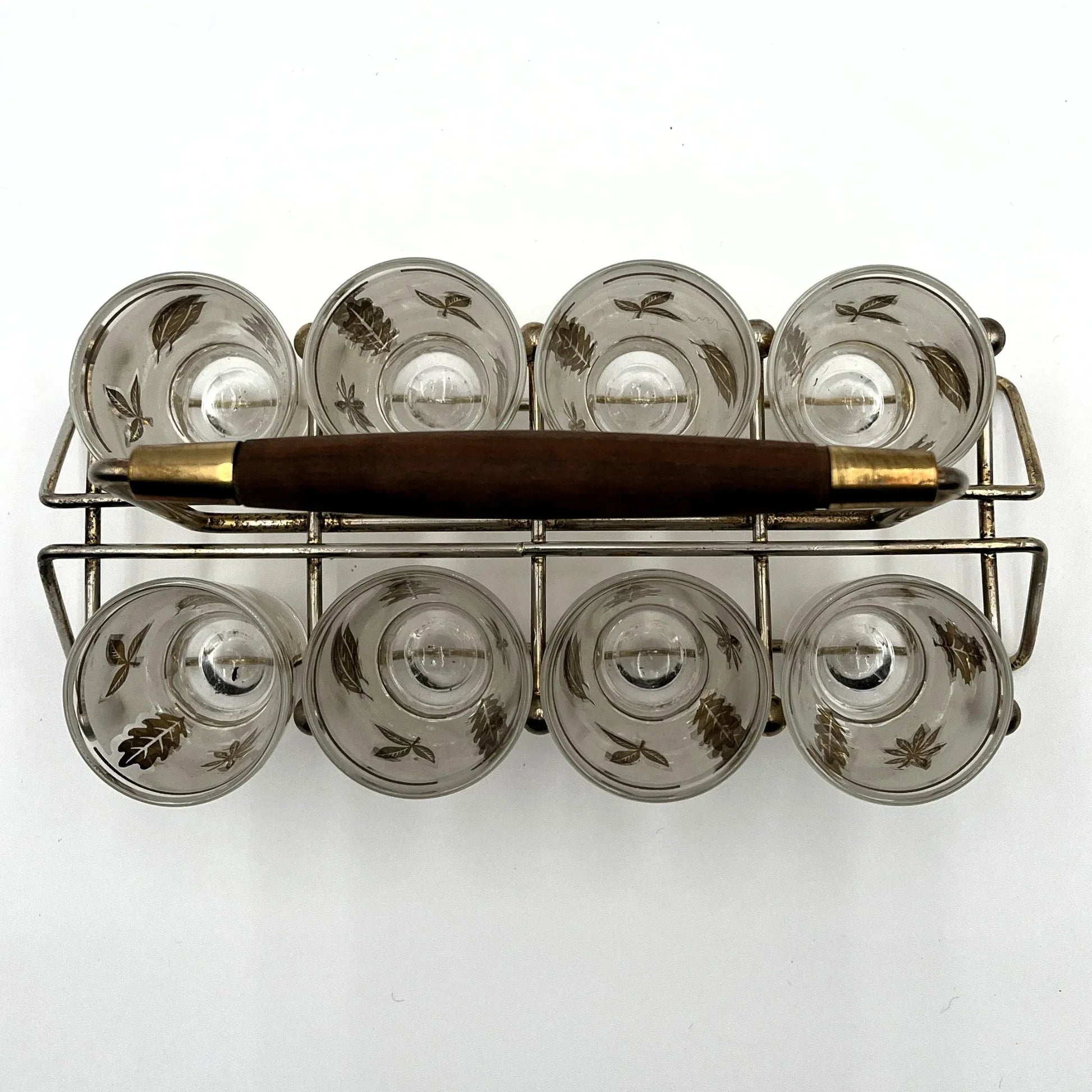 Manufactured in the 1960s, these are a set of 8 vintage Libby frosted gold foil leaf shot glasses, with their own stand.