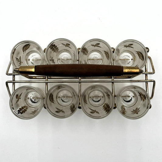 Manufactured in the 1960s, these are a set of 8 vintage Libby frosted gold foil leaf shot glasses, with their own stand.