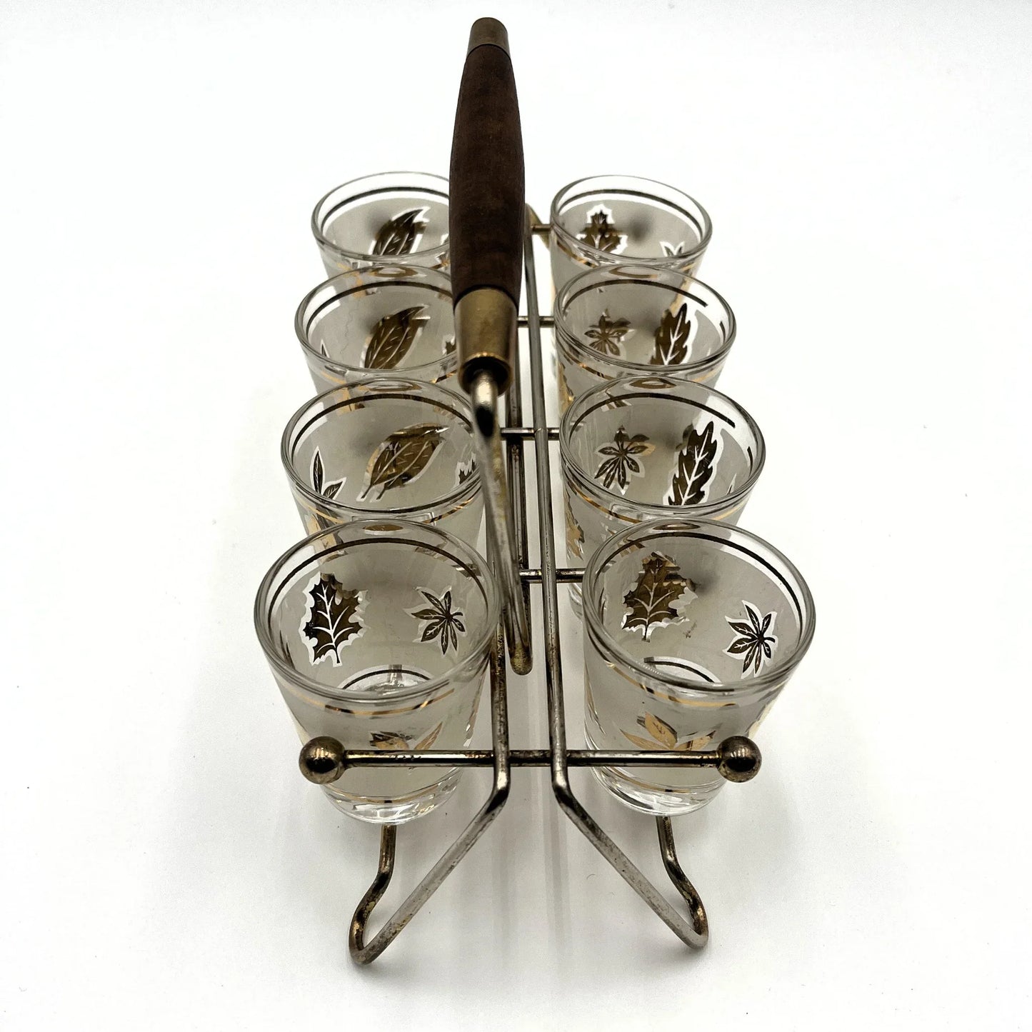 Manufactured in the 1960s, these are a set of 8 vintage Libby frosted gold foil leaf shot glasses, with their own stand.