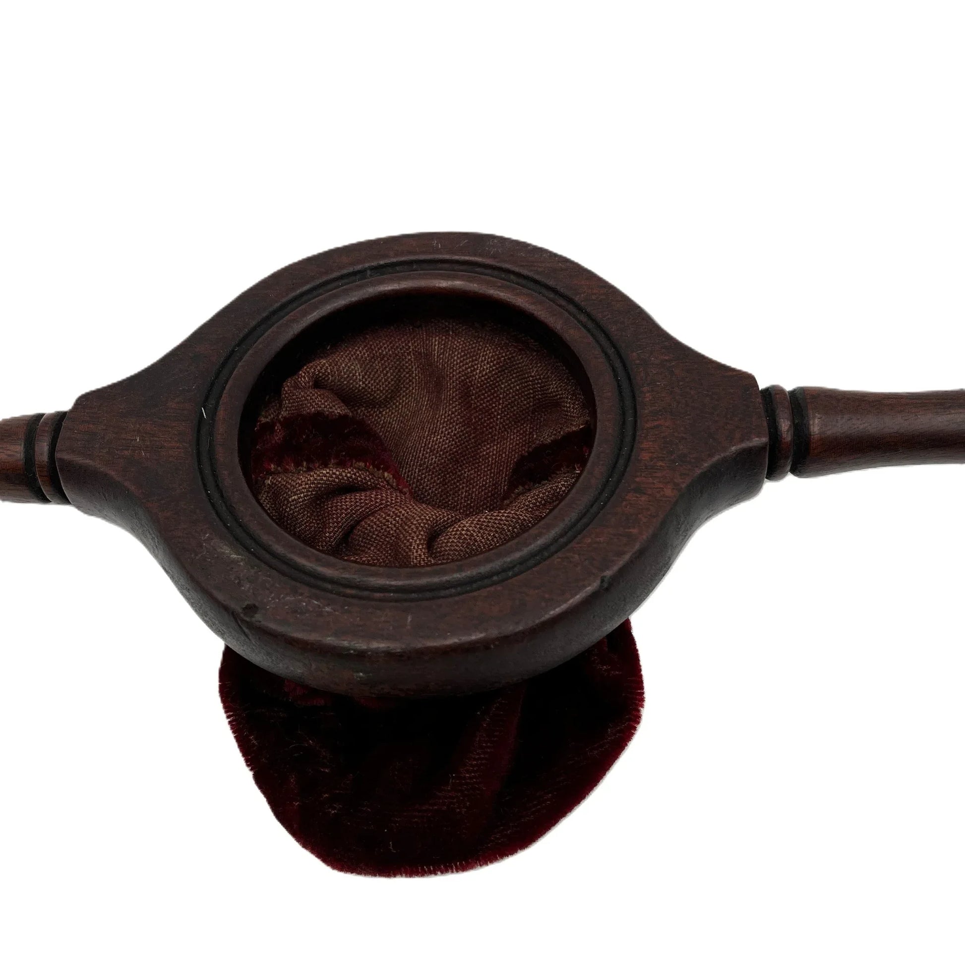 This is an antique wooden-handled church offering or collection velvet bag. These historical items were used in churches to collect tithes and donations from the congregation. 