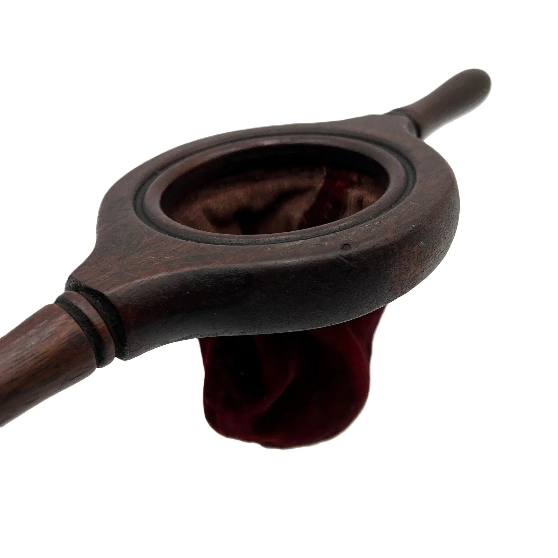 This is an antique wooden-handled church offering or collection velvet bag. These historical items were used in churches to collect tithes and donations from the congregation. 