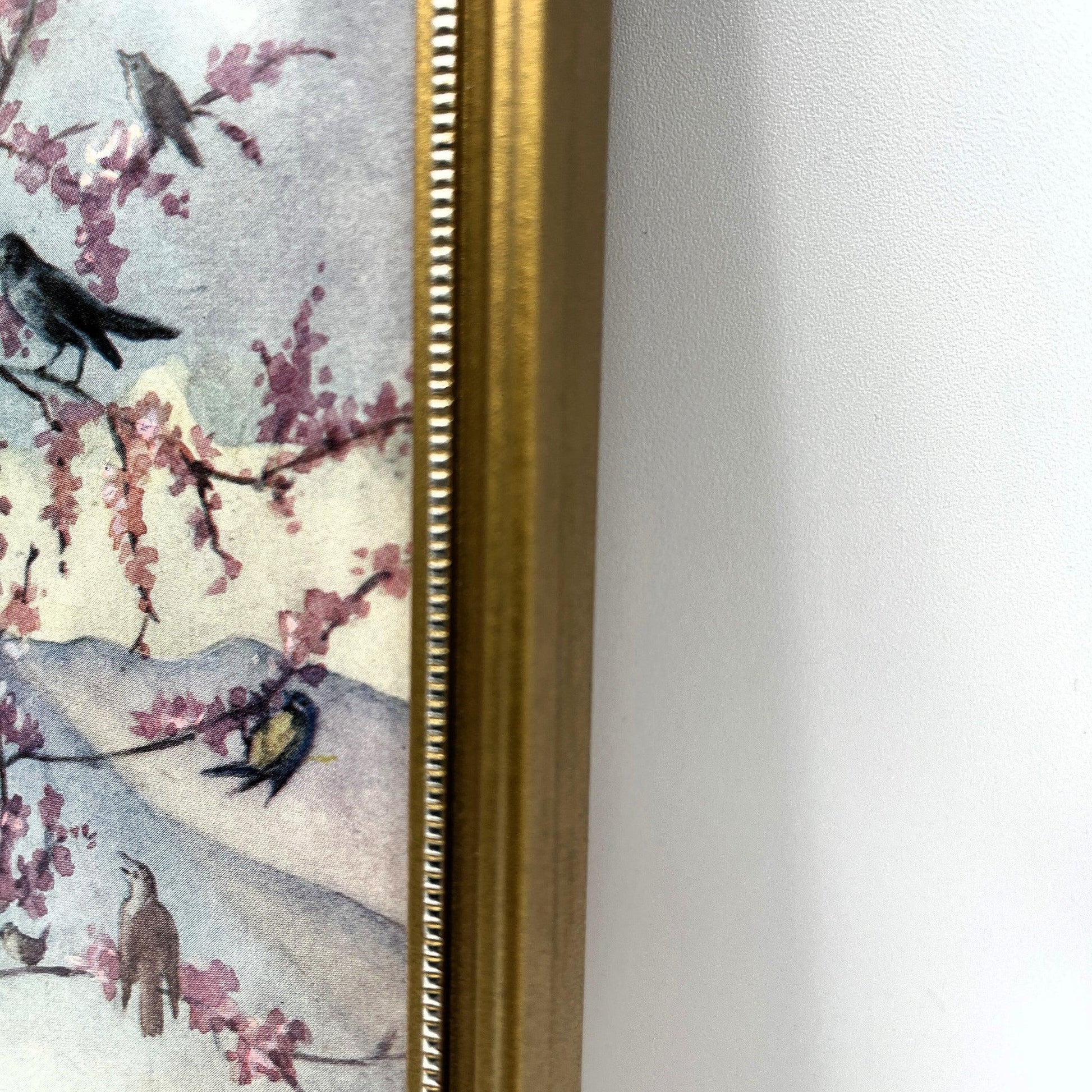 This is a framed print of the painting "Morning Carol" by the British illustrator Margaret Tarrant (1888-1959). The artwork depicts a child holding a rabbit, surrounded by other rabbits and birds under a blossoming tree, in a pastoral setting. 