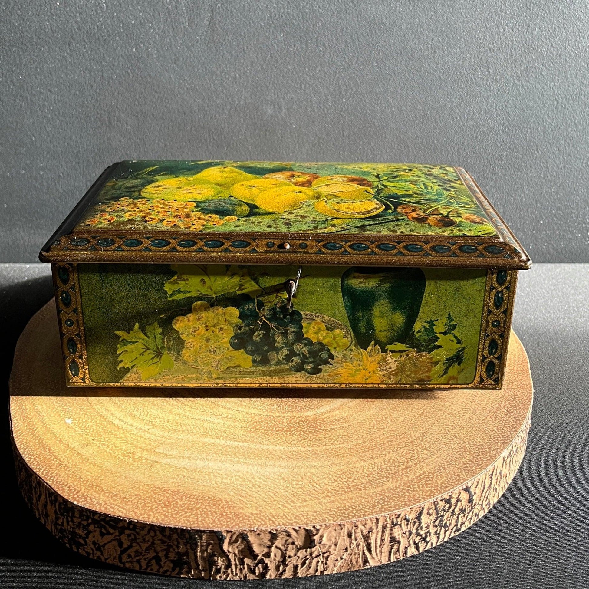 This antique fruit litho art hinged and footed Swiss sweet tin is a rare find for collectors of vintage tins and memorabilia. 
