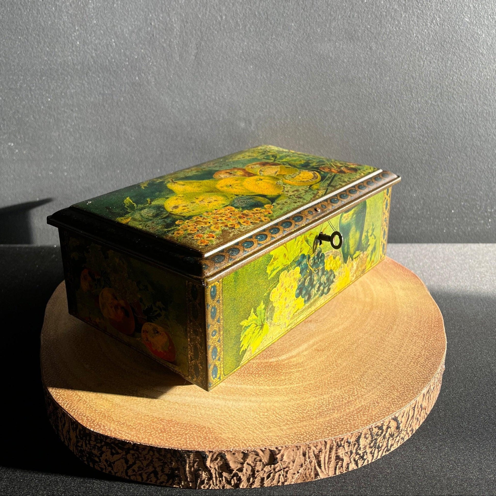 This antique fruit litho art hinged and footed Swiss sweet tin is a rare find for collectors of vintage tins and memorabilia. 