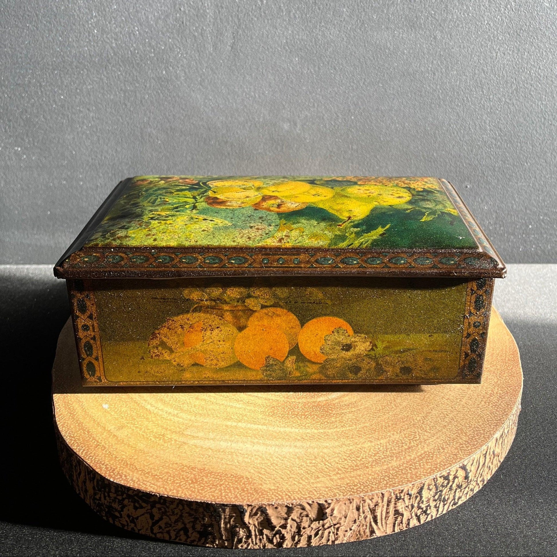 This antique fruit litho art hinged and footed Swiss sweet tin is a rare find for collectors of vintage tins and memorabilia. 