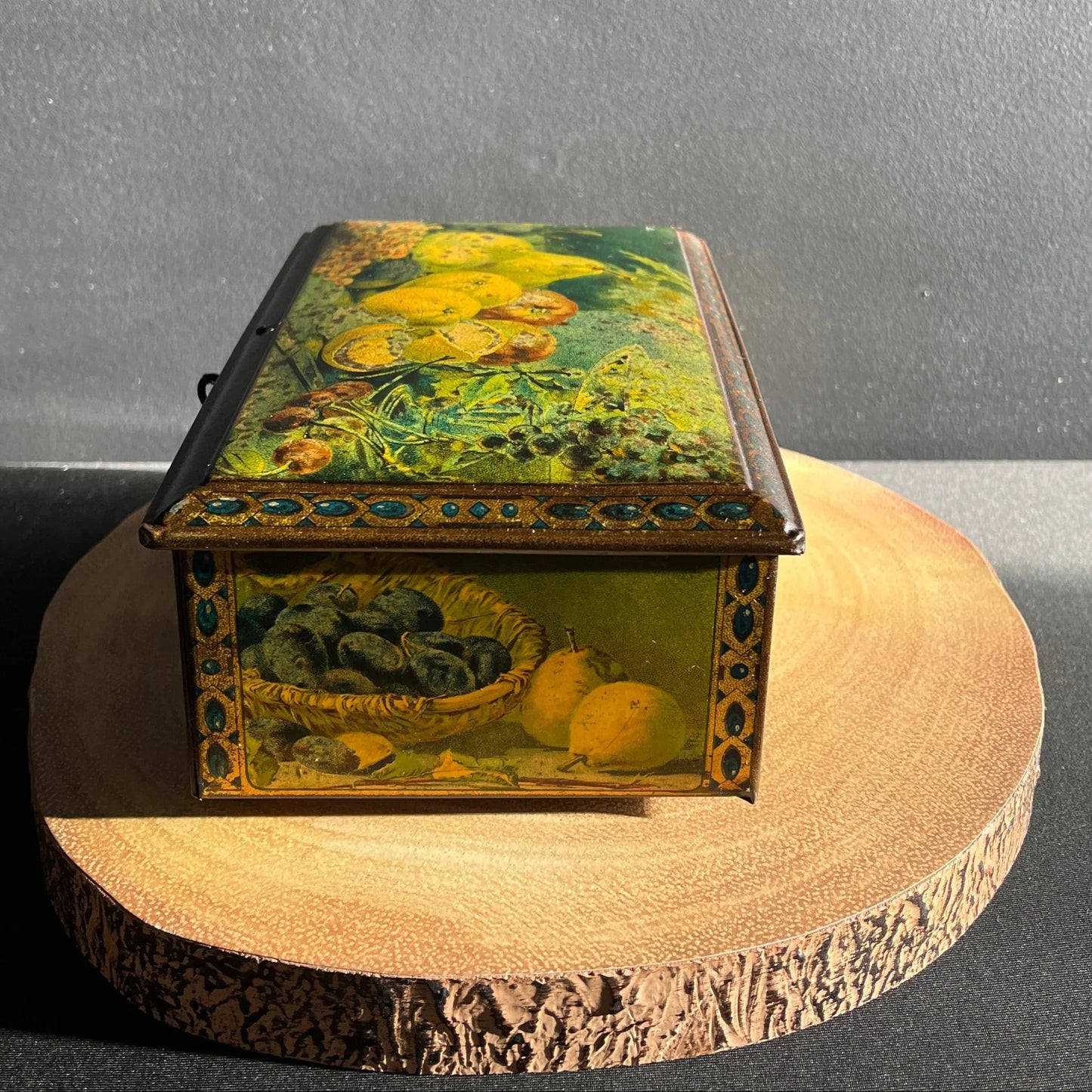 This antique fruit litho art hinged and footed Swiss sweet tin is a rare find for collectors of vintage tins and memorabilia. 