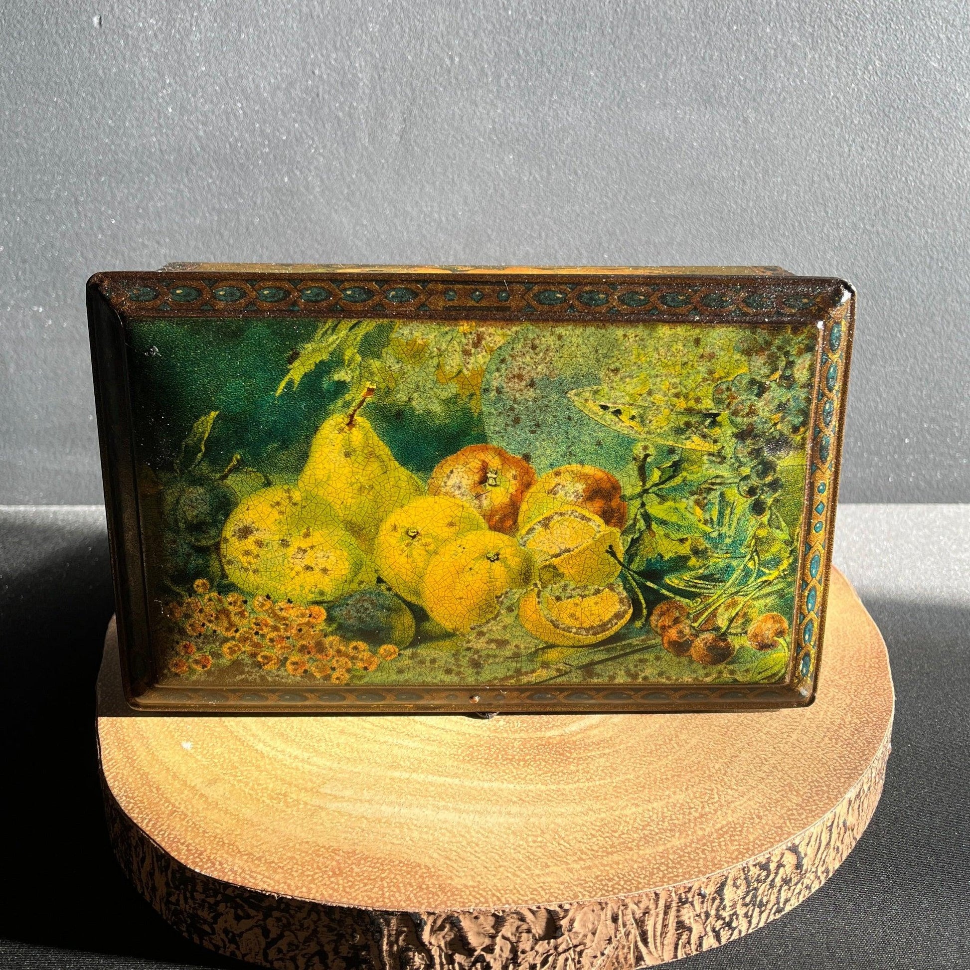 This antique fruit litho art hinged and footed Swiss sweet tin is a rare find for collectors of vintage tins and memorabilia. 