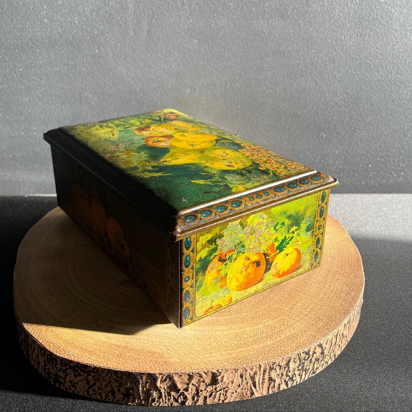 This antique fruit litho art hinged and footed Swiss sweet tin is a rare find for collectors of vintage tins and memorabilia. 